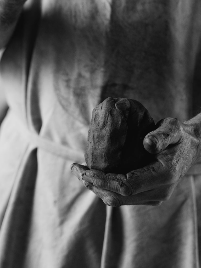 hand holding lump of clay
